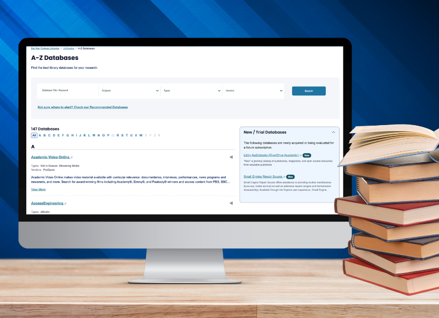 A computer screen with A to Z databases on the screen and a stack of books next to it
